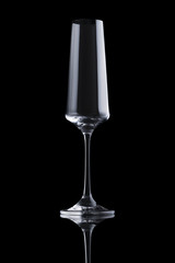Single transparent elegant luxury empty champagne glass with rectangular harsh highlight isolated on black background. Design element with clipping path.