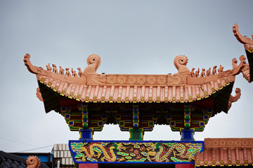 Colorful painted Asian gate and rooftop 