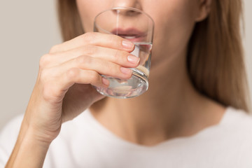 Close up of woman hold glass enjoy pure water