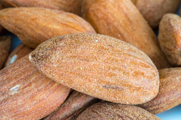 Closeup of fresh and dry peeled almond nut.