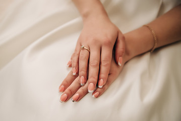 Nails of the bride on a white background