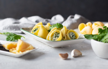 Italian pasta lumaconi stuffed with spinach and ricotta cheese, sprinkled with grated parmesan....