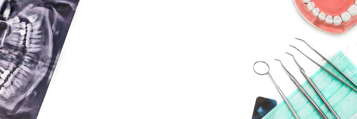 Banner made from dentist tools on mask and x-ray photo isolated on white background. Flat lay.