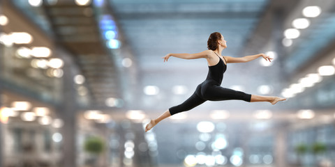 Fototapeta na wymiar Gymnast girl in jump Mixed media