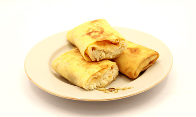 Pancakes with cottage cheese and raisins on a white background