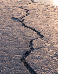 Cracked surface layer of ice at frozen lake