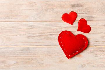 Fototapeta premium Top view of red textile hearts on wooden background with copy space. Romantic concept. St Valentine's Day