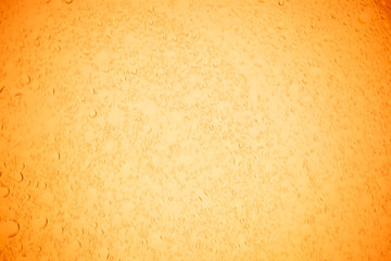 Rain droplets on yellow glass background, Water drops on yellow glass.