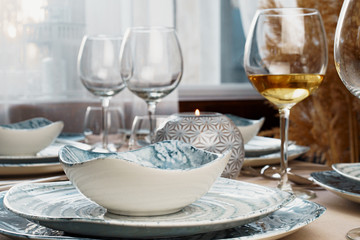 Table setting with stylish dishware on beige tablecloth