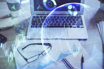 Financial graph colorful drawing and table with computer on background. Multi exposure. Concept of international markets.