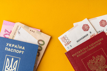 Ukrainian and russian passport with money, russian roubles and ukrainian hryvnia