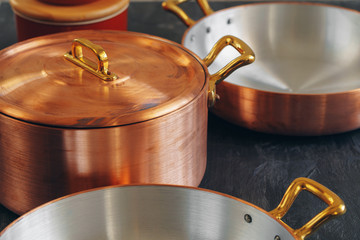 Clean copper cookware in kitchen close up