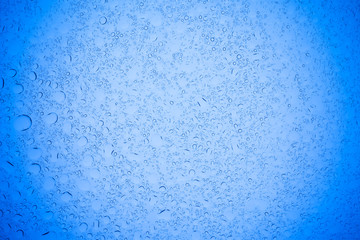 Rain droplets on blue glass background, Water drops on blue glass.