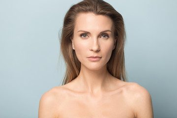 Portrait of beautiful young blue-eyed woman look at camera posing