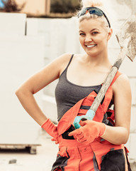 Woman using shovel on constriction site