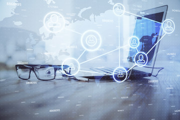 Computer on desktop with social network theme icon. Multi exposure. Concept of international connections.