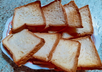 A set of m breads with eight slices slides placed on a homemade white plate