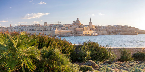Fototapeta premium Panoramic view of Valletta, seafront skyline of the capital city of Malta from Sliema shoreline with green flora
