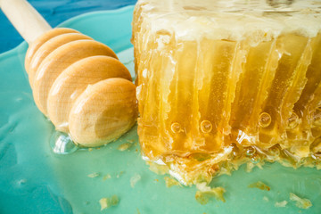 Fototapeta na wymiar Honey with wooden honey dipper and honeycombs