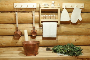 Copper accessories for sauna in the wooden interior.