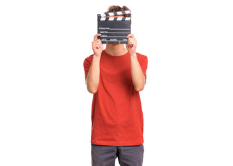 Teen boy hiding behind cinema clapper board, isolated white background. Teenager cover face. Funny...