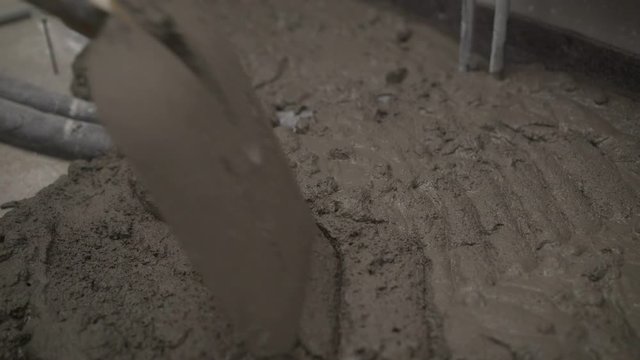 Worker laying floor with mortar. Mortar is laid on the floor. Laying tiles at home. Construction worker laid floor tiles. in thiland