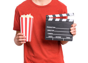 Teen boy hands with cinema clapper board and popcorn bucket, isolated white background. Child...