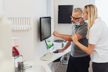 Dentist discussing an X-ray with a patient
