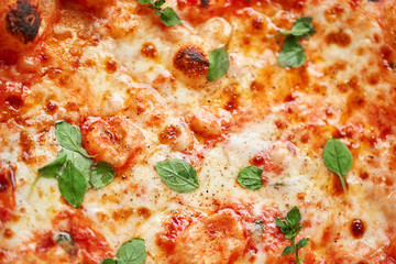 Pizza Margarita. Baked tasty margherita pizza in Traditional wood oven in Neapolitan restaurant, Italy.