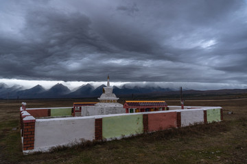 Buddhist stupa on a background of mountains. Cloudy evening