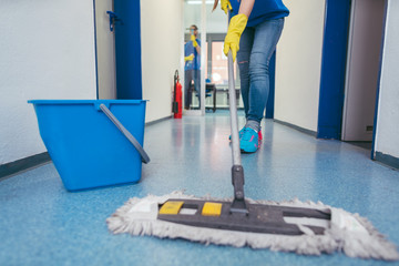 Close-up of cleaners moping the floor