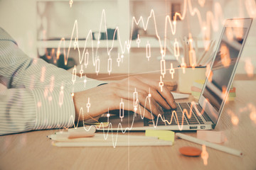 Double exposure of stock market graph with man working on laptop on background. Concept of financial analysis.