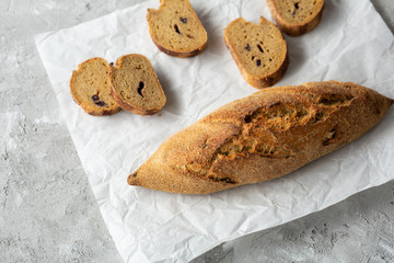 Fresh loaf bread top view on white, whole grain