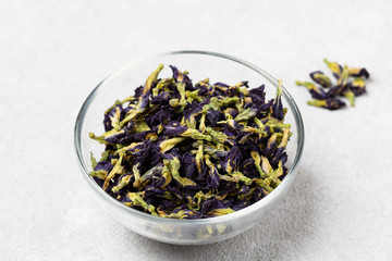 Organic blue tea Anchan, Clitoria, Butterfly Pea. Blue Anchan tea, dried tea flowers(Flowers of the clitoris triplicate)  in a bowl.  