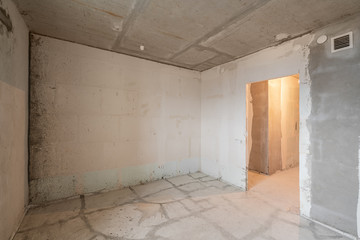 Empty interior for design, gray concrete wall. Empty room. Space for text and picture. Concrete walls, slabs, interior of a new residential building. Partitions in a new apartment.