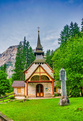 Fototapeta na wymiar Amazing alpine scenery with small chapel at Lago di Braies Lake, Dolomite Alps, South Tyrol, Italy