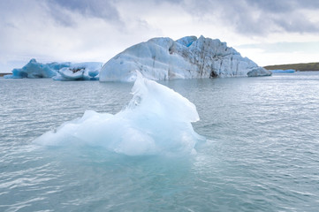 Fototapeta na wymiar Blue icebergs floating in the jokulsarlon lagoon in Iceland in theautumn