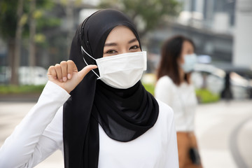 muslim woman wearing mask, stopping virus outbreak; concept of biohazard, biological hazard,...