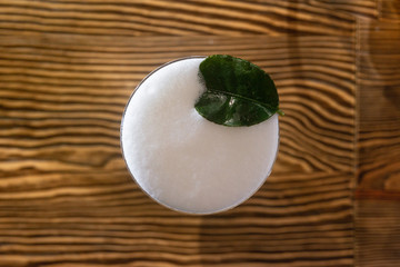 Top view of cocktail served on the wooden bar desk. 