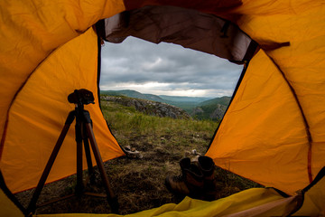 view from a tent standing in the mountains at dawn in Bashkortostan