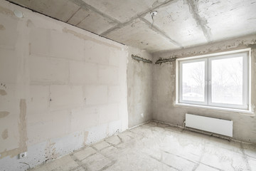 Empty interior for design, gray concrete wall. Empty room. Space for text and picture. Concrete walls, slabs, interior of a new residential building. Partitions in a new apartment.