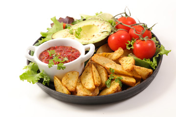 plate of french fries, salad and tomato sauce isolated on white background