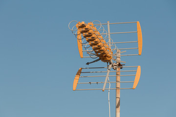 vhf television antenna in front of blue sky