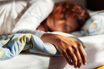 Fototapeta premium Beautiful sleeping woman in white ornamental clothes.