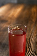 Pink and red Fresh colorful exotic alcoholic cocktail with lemon and ice in the bar. Colorful pink Soft drink with ice and decorated with dried flowers on the bar desk. Red colorful Mojito