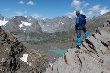 A mountain climber looking at gorgeous alpine landscape. Upper stream of Kurkus river, Katun range,...