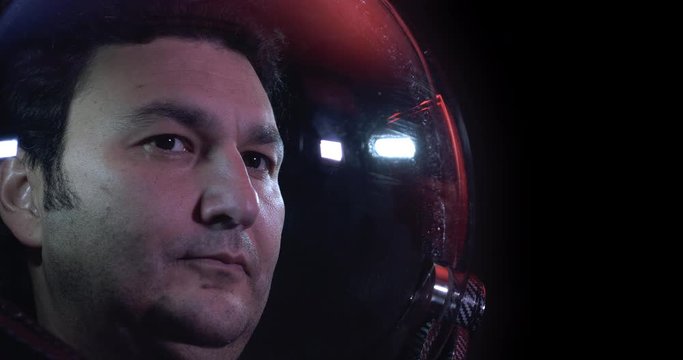 Close Up 4K Shot Of The Young Courageous Male Astronaut In Space Helmet. He Is Exploring Outer Space In A Space Suit. Science And Technology Related 4K Concept Footage.