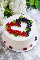 Round white cake with berries in the form of hearts, Valentine's Day, on white background. Picture for a menu or a confectionery catalog. Top view