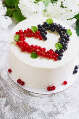 Round white cake with berries in the form of hearts, Valentine's Day, on white background. Picture for a menu or a confectionery catalog. Top view