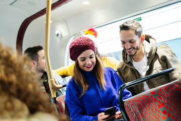 Some friends with the mobile phone on a bus